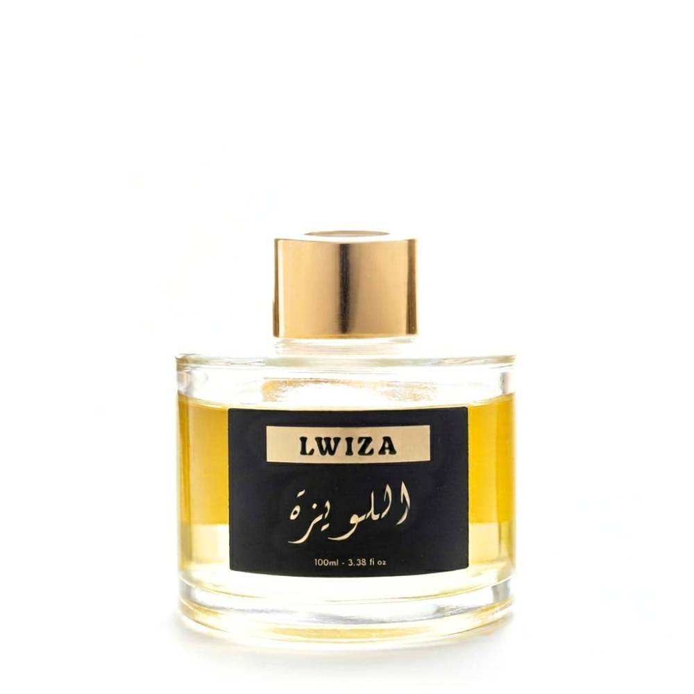 Flacon cylindrique de parfum LWIZA 100ml, liquide doré, capuchon doré et étiquette noire élégante.

